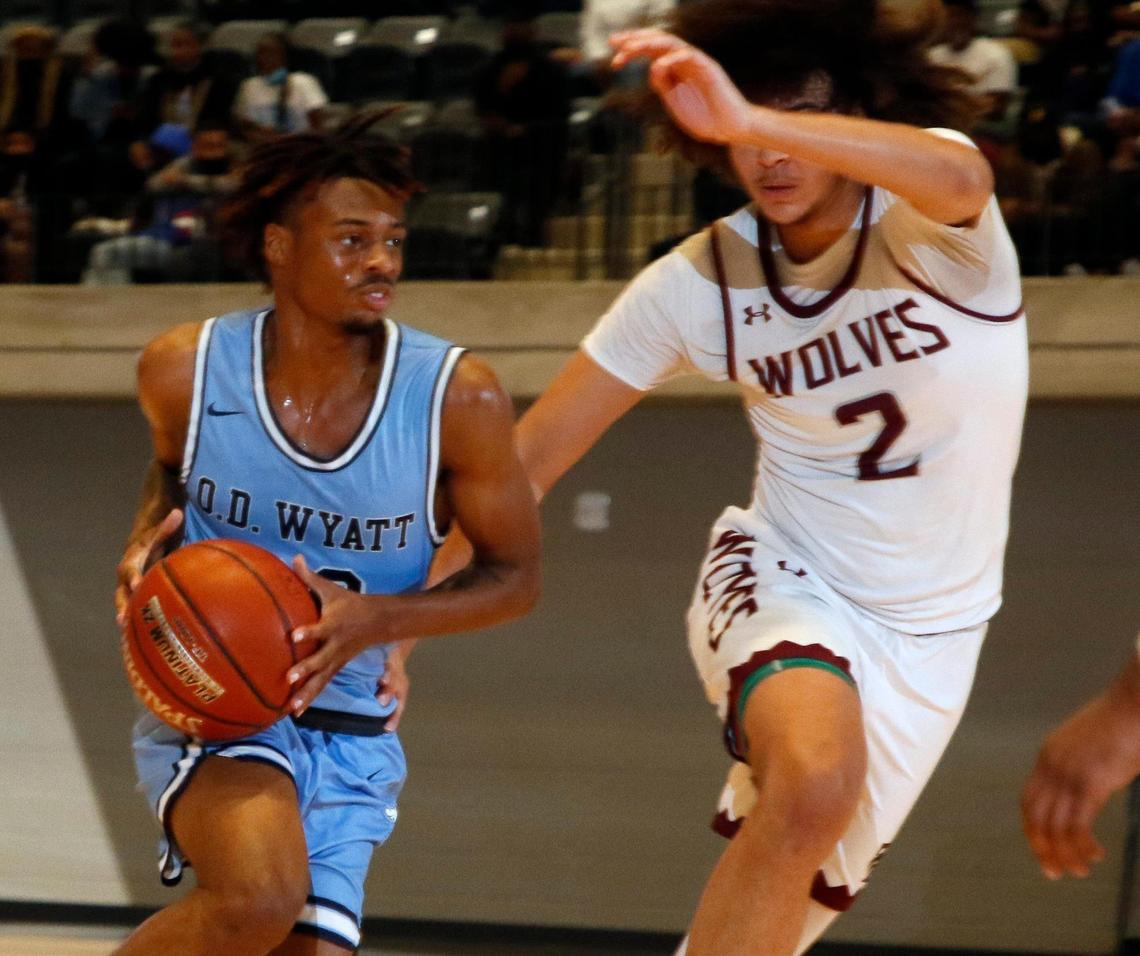 Wyatt guard Kendall Fair (30) drives into the key defended by Timberview forward Cameron Taylor (2) during the first half of a Division 5A Region 1 quarterfinal basketball game at Arlington ISD Athletics Complex in Arlington, Texas, Saturday, Feb. 27, 2021. O.D. Wyatt led at the half. (Special to the Star-Telegram Bob Booth)