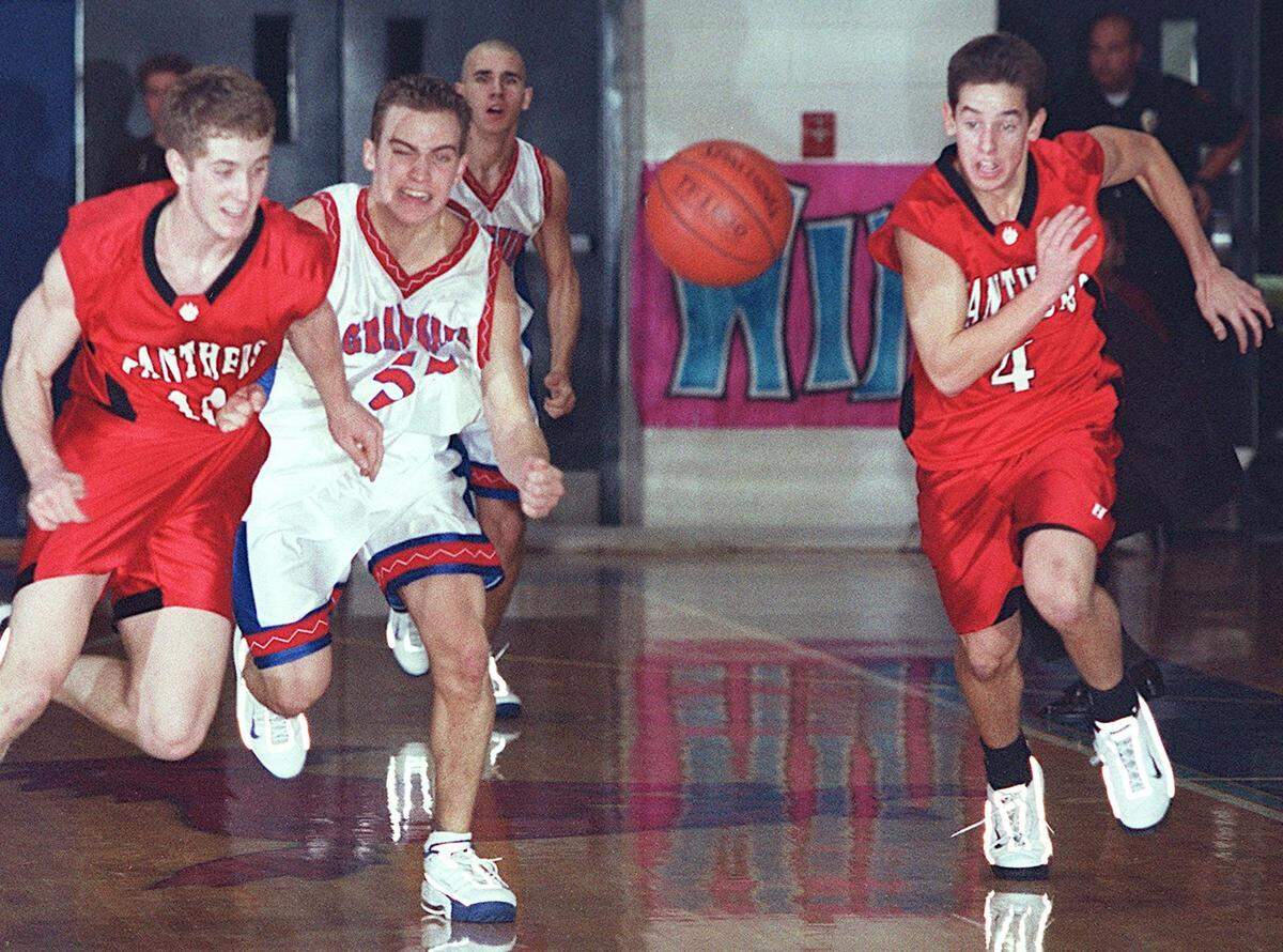Going for a loose ball from left to right are Austin Henley of Colleyville, Kyle Henning of Grapevine, and David Markley of Colleyville during a varsity basketball game between Colleyville High School and Grapevine High School on Tuesday October 14, 2000. Star-Telegram/Khampha Bouaphanh