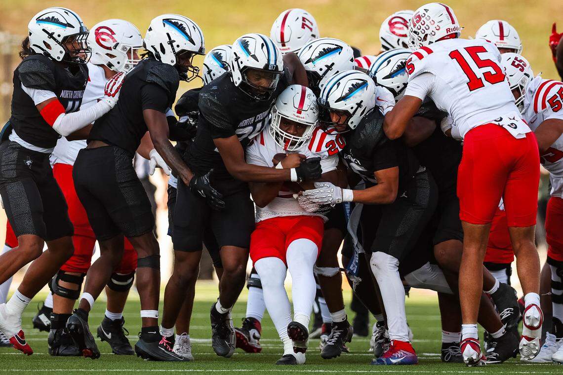 North Crowley defenders attempt to tackle Coppell running back Jayden George (20) in a Class 6A Division I regional playoff Saturday.