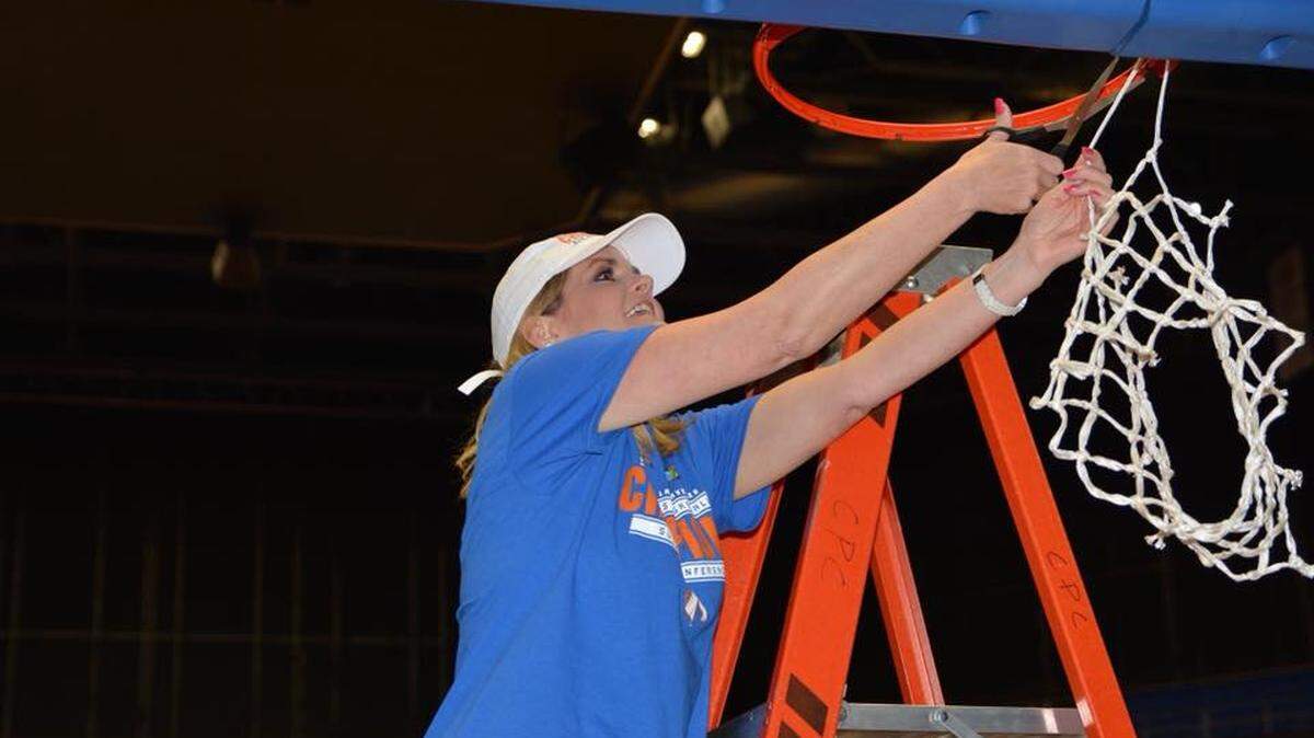 UTA coach Krista Gerlich cuts down the nets after the Mavs clinch their first regular season conference title in 10 years.
