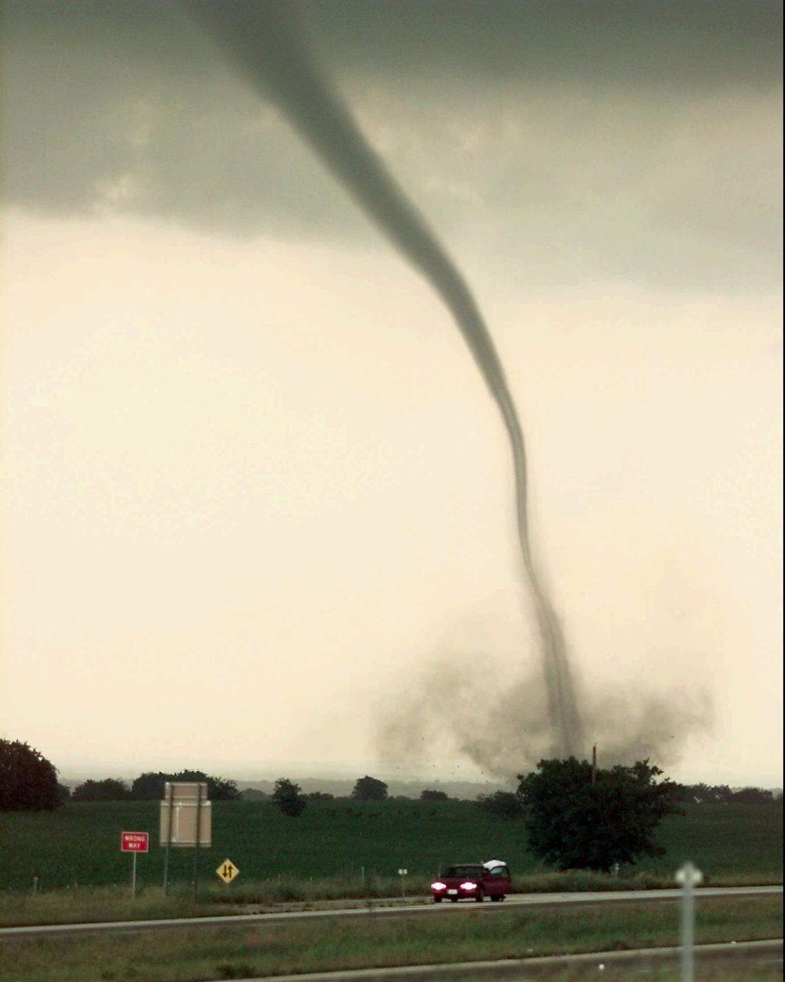 A funnel cloud touches down north of Jarrell, Texas, along Interstate 35 on May 27, 1997. Violent storms ripped throught four Central Texas counties. Some 20 homes in a subdivision in Jarrell were flattened. (AP Photo/Austin American-Statesman, Ted S. Warren)