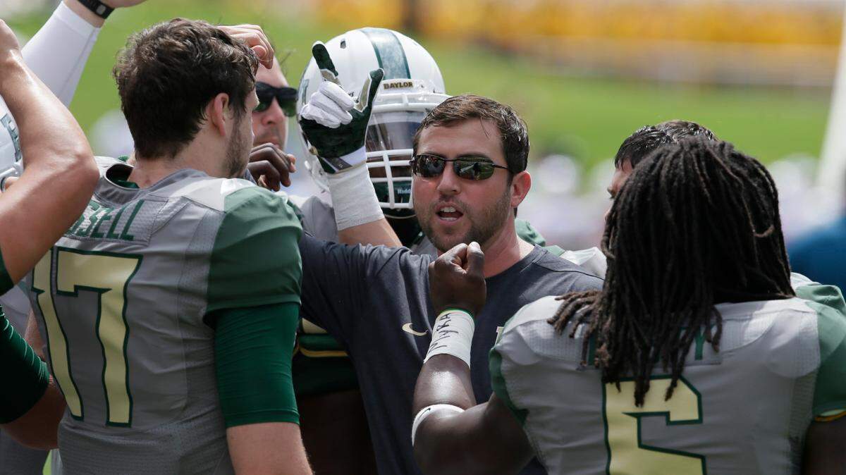 Kendal Briles, center, former offensive coordinator at Baylor, talks to his players before a football game against SMU in 2016, in Waco.
