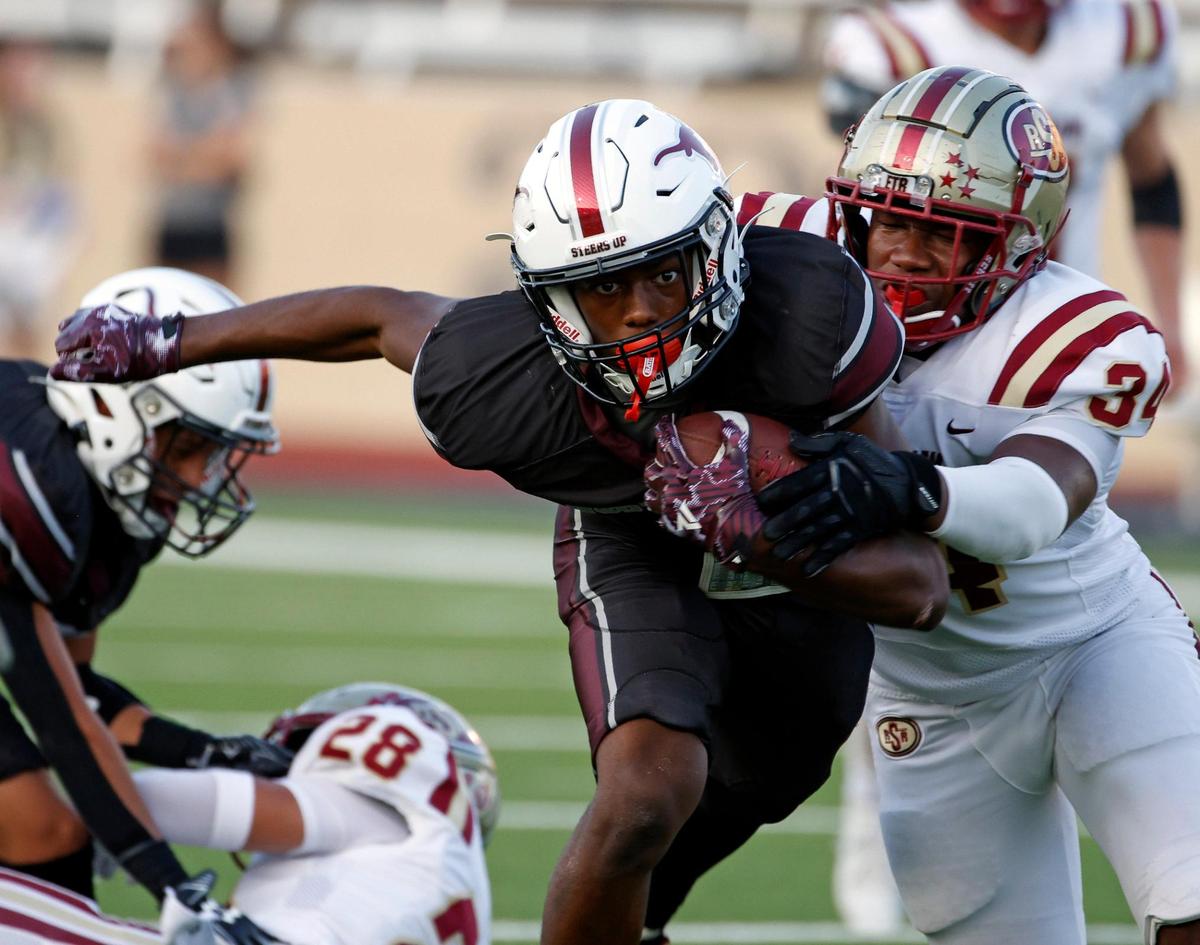 North Side wide receiver DeAndre Montgomery (7) is grabbed from behind by Saginaw defensive end Frank Westmoreland (34)in the first half of a UIL football game at Farrington Field in Fort Worth,Texas, Friday Sept. 01, 2023. North Side led 14-7 at the half. (Special to the Star-Telegram Bob Booth)