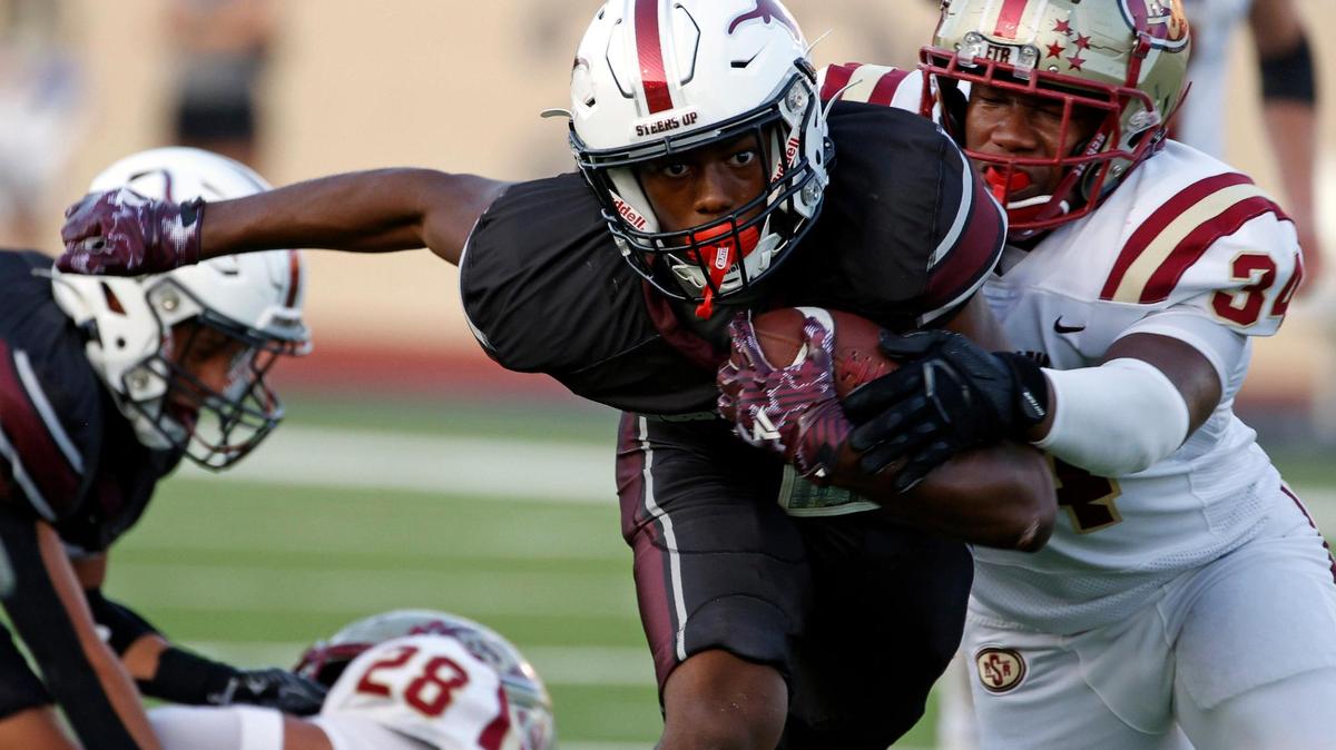 North Side wide receiver DeAndre Montgomery (7) is grabbed from behind by Saginaw defensive end Frank Westmoreland (34)in the first half of a UIL football game at Farrington Field in Fort Worth,Texas, Friday Sept. 01, 2023.
