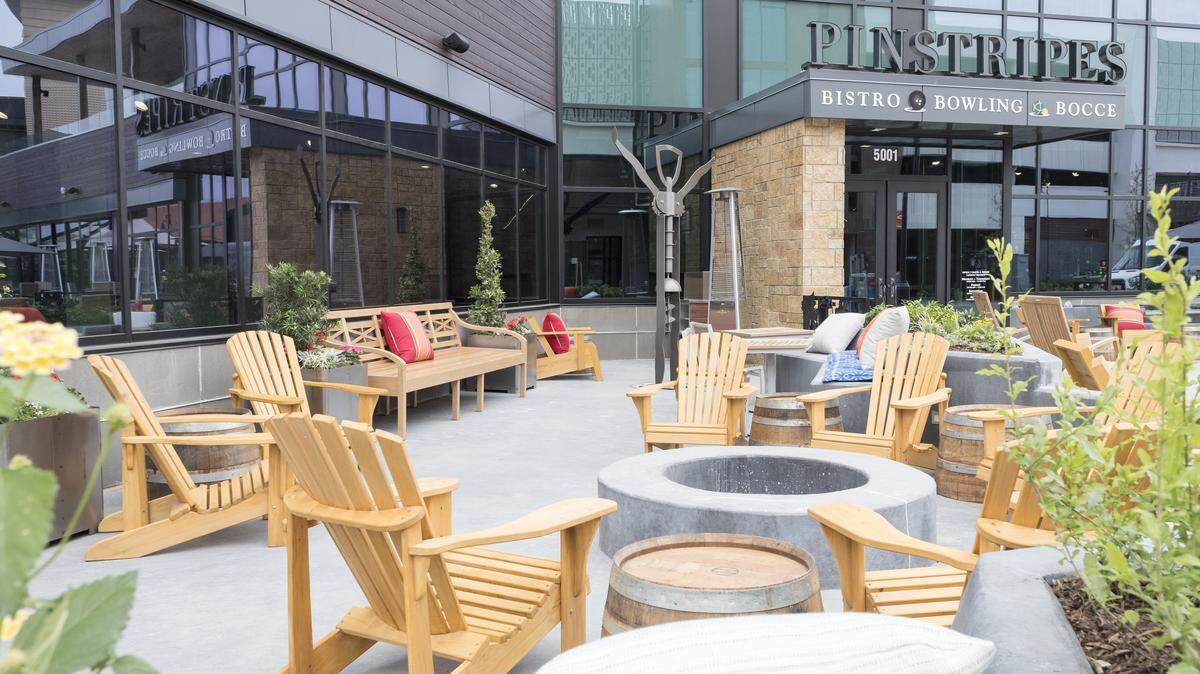 Part of the patio area at Pinstripes (Bistro + Bocce + Bowling) at the Shops at Clearfork in Fort Worth. Note the fire pit, the wine-barrel tables and the corkscrew sculpture -- a nod to Pinstripes' wine program.
