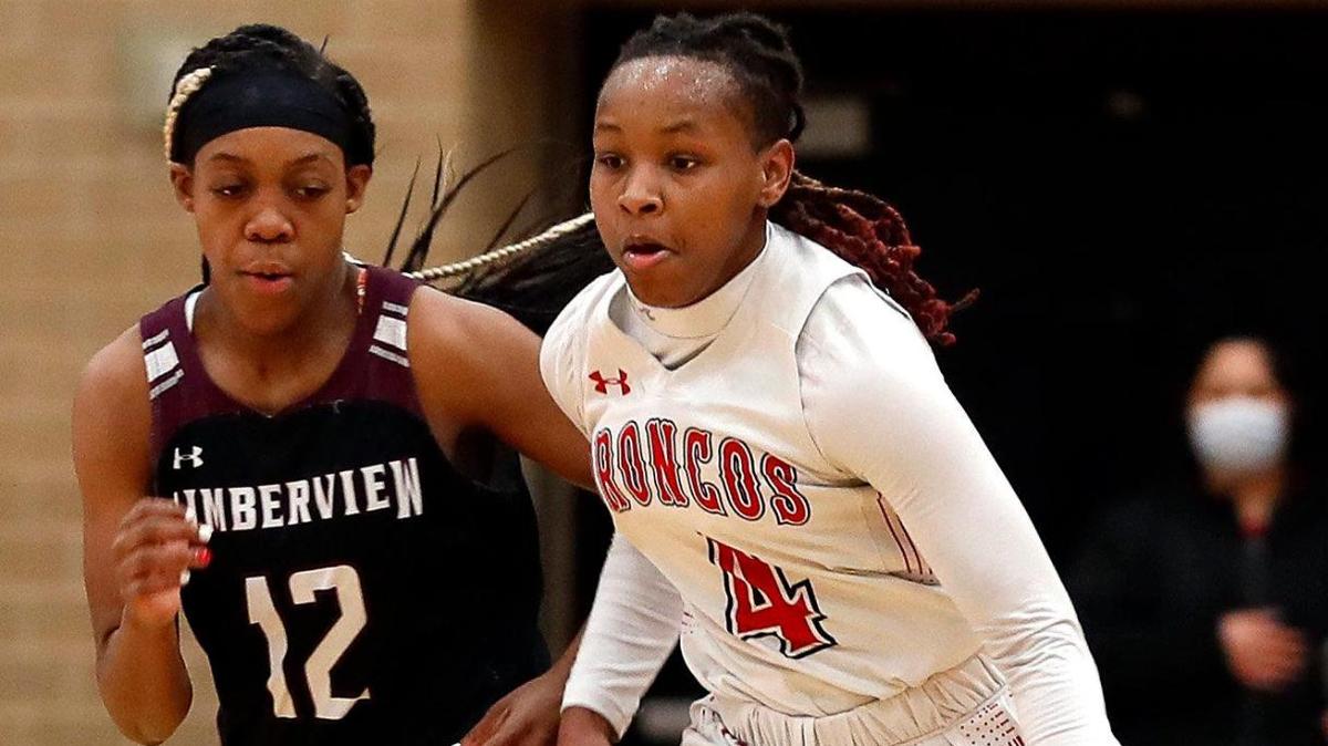 Legacy guard Sirviva Legions (4) drives the ball ahead of Timberview forward Chrishawn Coleman (12) and guard Stephanie Mosley (0) in the first half of a 8-5A district high school girls basketball game at Legacy High School in Mansfield, Texas, Friday, Jan. 22, 2021. The Lady Broncos led the Lady Wolves 22-11 at the half. (Special to the Star-Telegram Bob Booth)