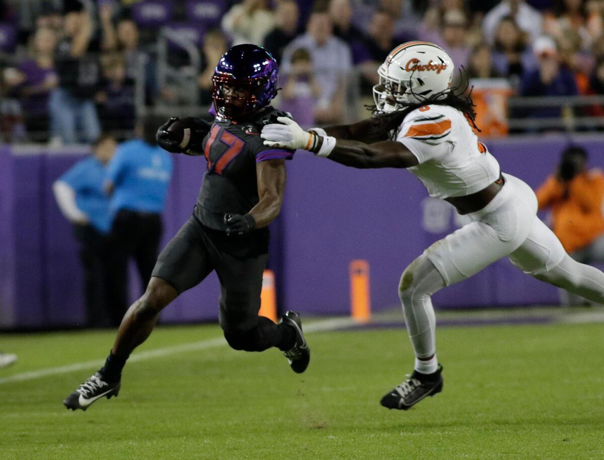 TCU’s Trent Battle breaks the tackle of Parker Robinson during a Big XII football game at Amon G. Carter Stadium on Saturday November 9, 2024.