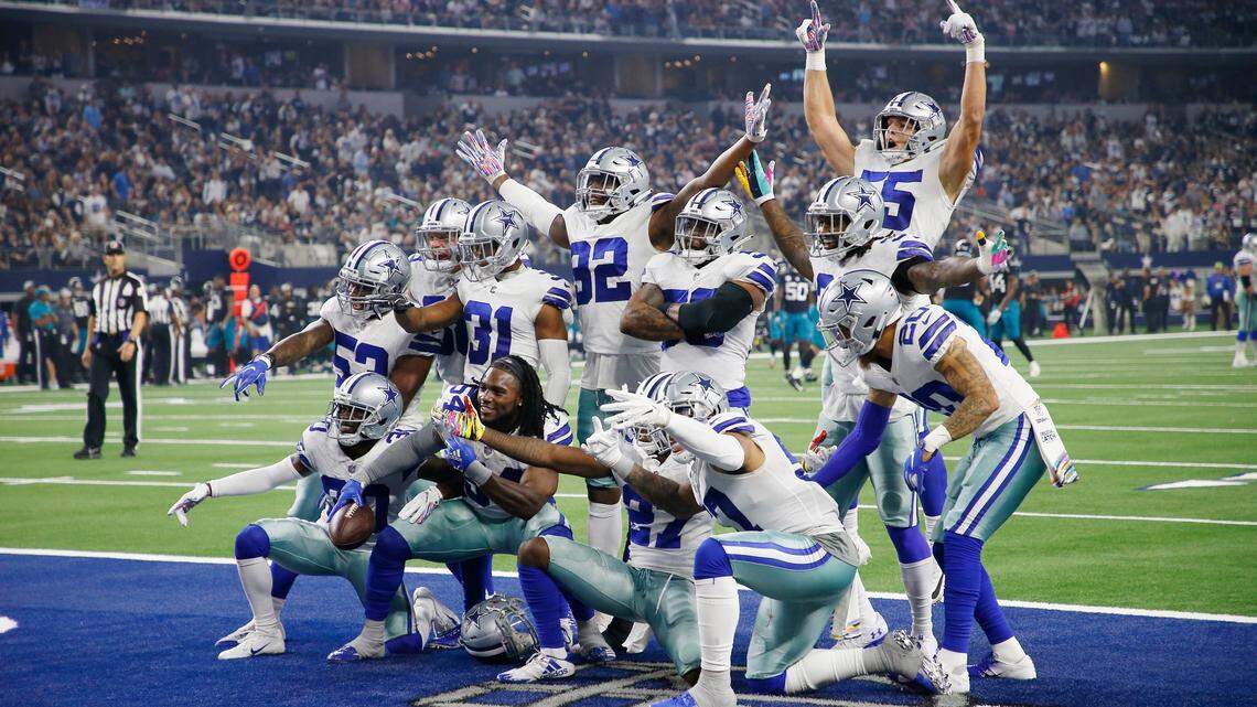 The Dallas Cowboys defense celebrates recovering a Jacksonville Jaguars fumble in the second half of a 40-7 win at AT&T Stadium.