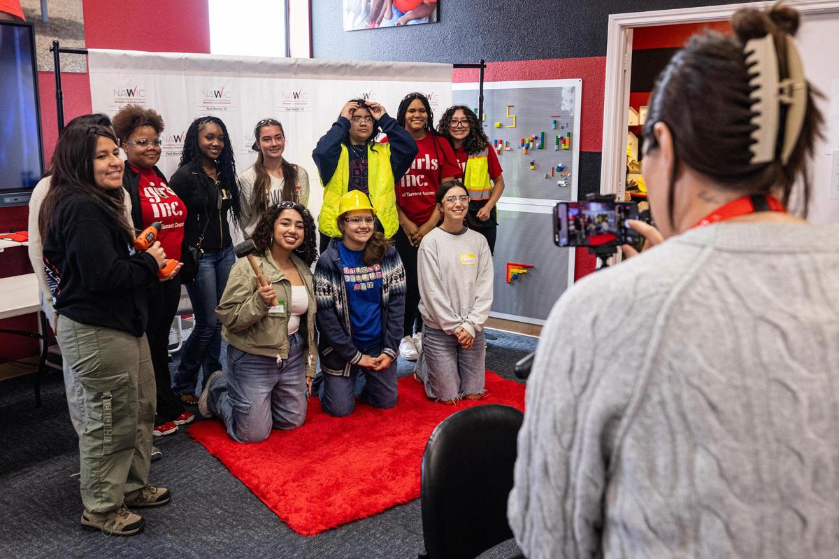 High schoolers pose for a photo with construction photo props on during the ‘Women in Construction’ event by Girls Inc. of Tarrant County at their headquarters in Fort Worth on Saturday, March 8, 2025.