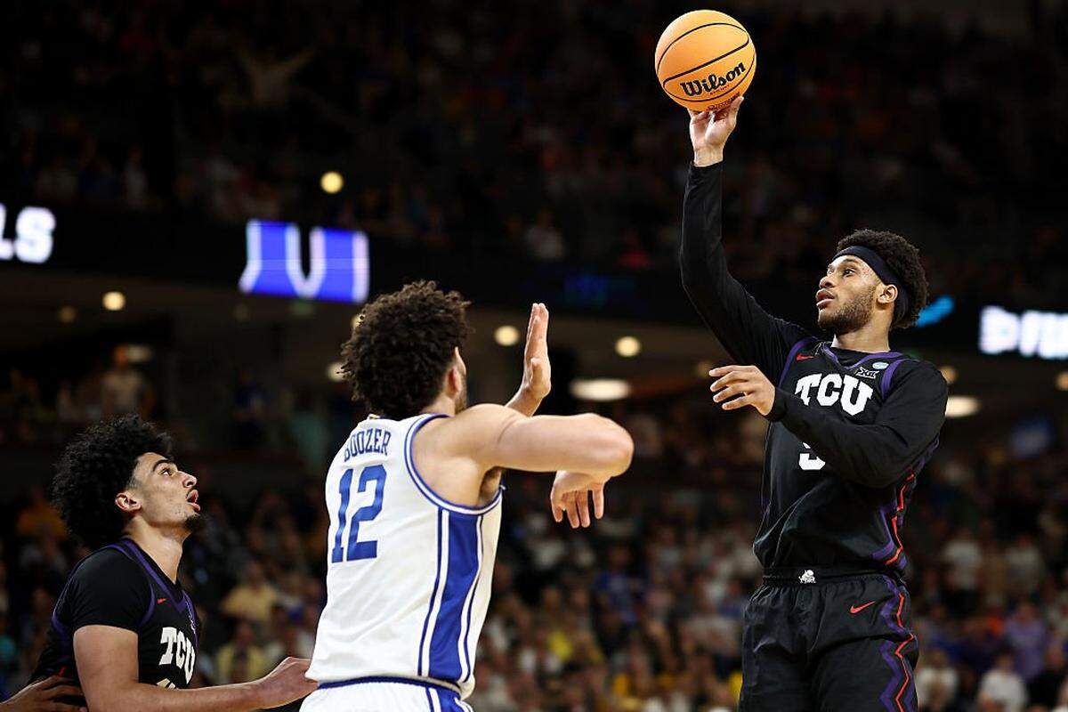 GREENVILLE, SOUTH CAROLINA - MARCH 21: Micah Robinson #5 of the Texas Christian University Horned Frogs shoots the ball against Cameron Boozer #12 of the Duke Blue Devils during the second half in the second round of the 2026 NCAA Men's Basketball Tournament at Bon Secours Wellness Arena on March 21, 2026 in Greenville, South Carolina. (Photo by Jared C. Tilton/Getty Images)