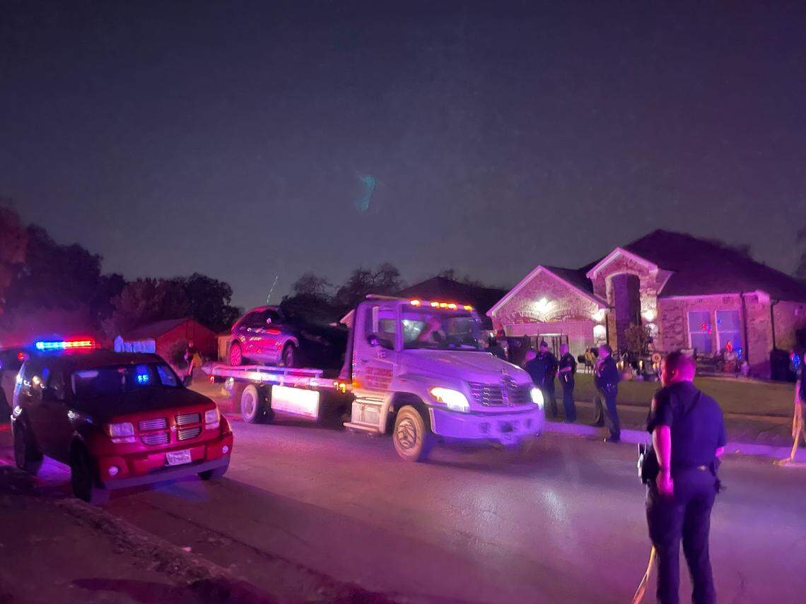A wrecker moves a bullet-riddled car from the scene of a fatal shooting in the 1200 block of Jessamine Street in south Fort Worth on Friday night, Oct. 7, 2022.