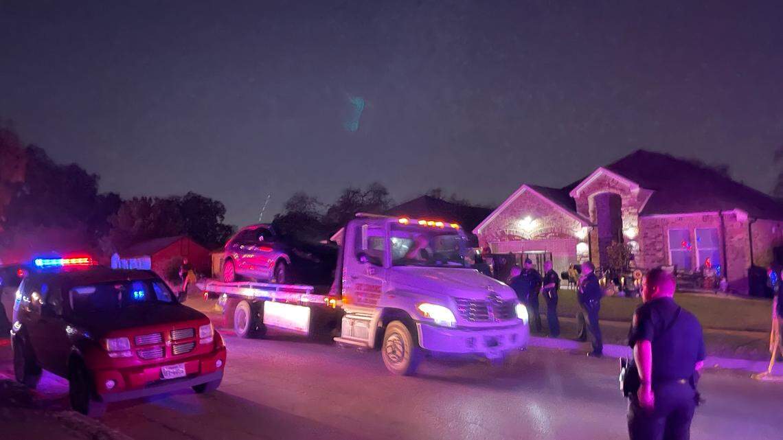 A wrecker moves a bullet-riddled car from the scene of a fatal shooting in the 1200 block of Jessamine Street in south Fort Worth on Friday night, Oct. 7, 2022.