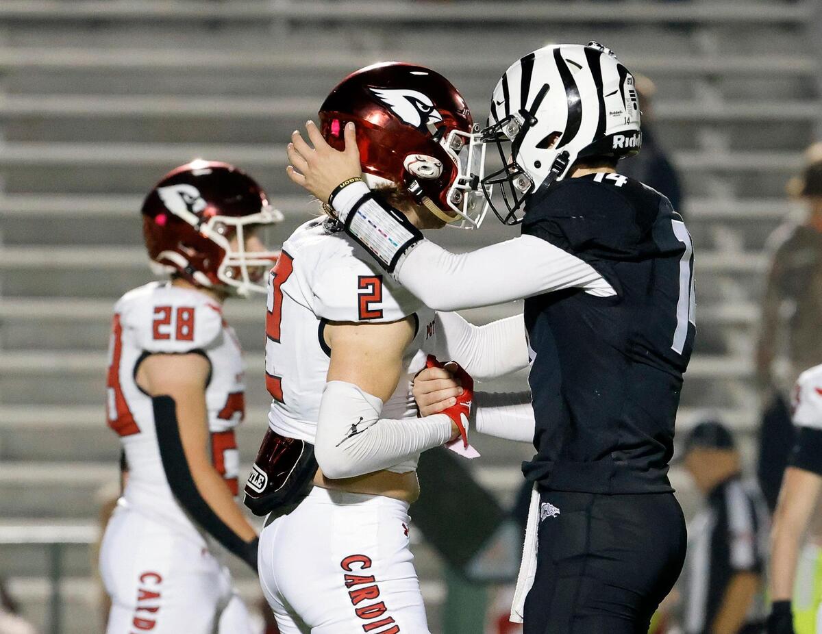 Grandview quarterback Ryder Hayes (14) consoles Pottsboro wide receiver Cameron Saunders (2) after their UIL Class 3A Division 1 area round playoff football game at Mesquite Memorial Stadium in Mesquite, Texas, Thursday, Nov. 16, 2023. Hayes said he thought Saunders looked down and gave him some words of encouragement.