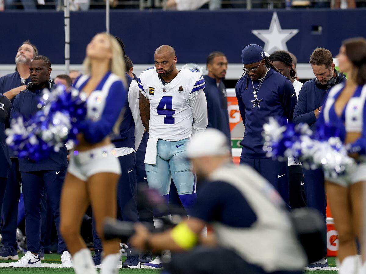 Dallas Cowboys quarterback Dak Prescott and others observe a moment of silence for conservative commentator Charlie Kirk before the game against the New York Giants on Sunday at AT&T Stadium