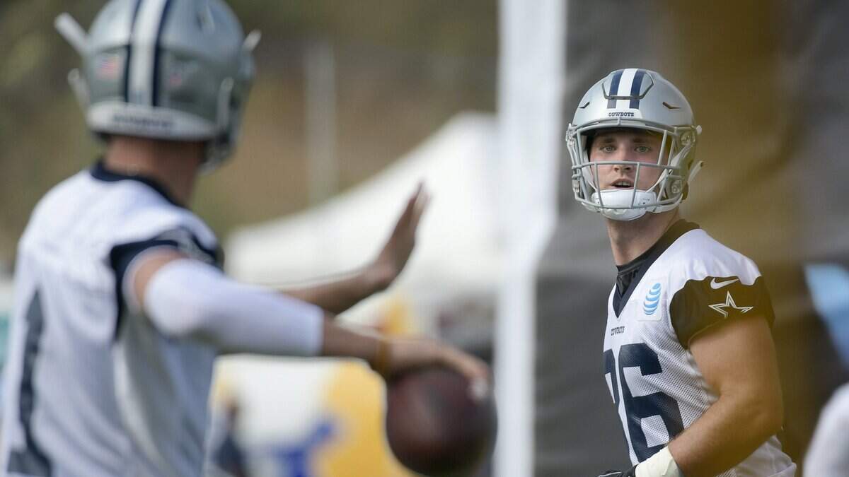 Cowboys quarterback Dalton Sturm, left, targets tight end Dalton Schultz for a pass during the first practice at training camp in Oxnard, Calif., on Thursday. Schultz left Saturday’s practice early to go be with his girlfriend, who is expecting their first child.