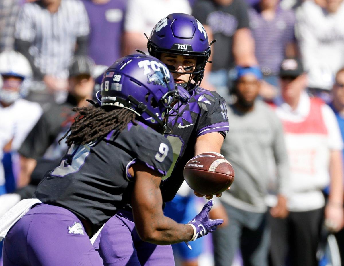 TCU quarterback Josh Hoover (10) hands the ball to running back Emani Bailey (9) during their Big 12 game against BYU on Saturday at Amon G. Carter Stadium.