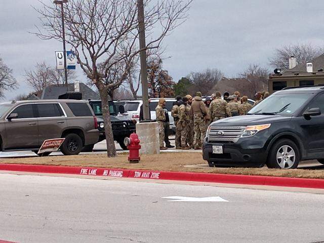SWAT team members gathered at Colleyville Middle School, 1100 Bogart Drive, as police negotiated with a man who took hostages inside a nearby synagogue on Saturday, Jan. 15, 2022.