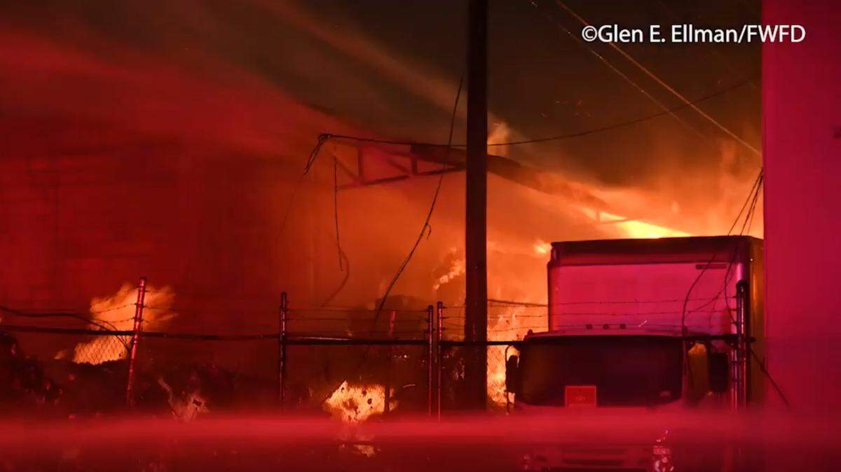 Fort Worth firefighters battle a blaze at a warehouse containing hand sanitizer in the 2300 block of Cullen Street, just northwest of downtown, on Oct. 6. Hand sanitizer bottles have littered the water and banks of the Trinity River since the fire.