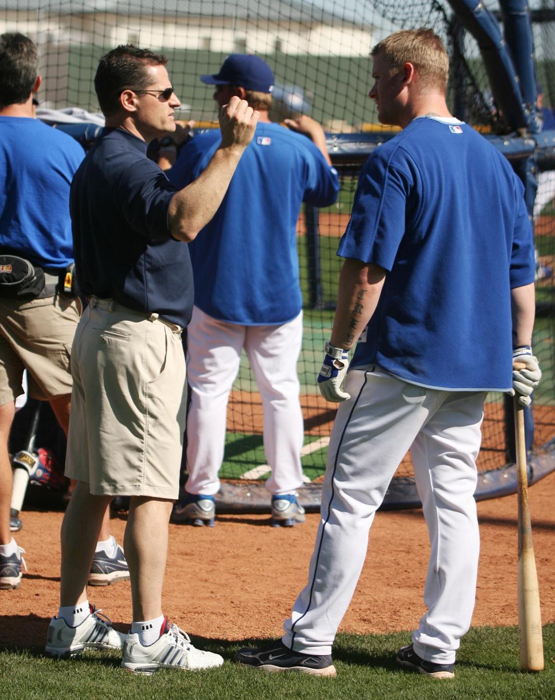 Texas Rangers team physician Dr. Keith Meister, left, speaks with former third baseman Hank Blalock in this file photo from the late 2000s.