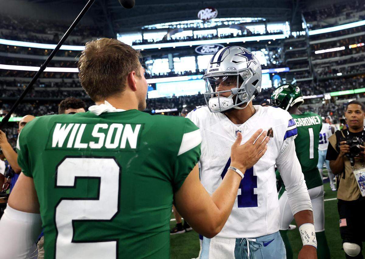 Dallas Cowboys quarterback Dak Prescott talks to New York Jets quarterback Zach Wilson following a 30-10 victory on Sunday, September 17, 2023, at AT&T Stadium in Arlington.