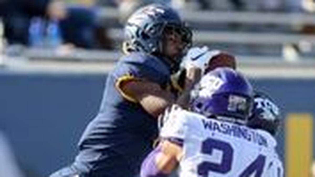 TCU safety Ar’Darius Washington (24) makes a play during the West Virginia game on Saturday.