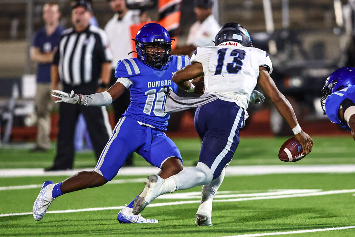 Wyatt quarterback Jorvorskie Lane, Jr. gets hemmed in by Dunbar’s Bryce Allen (10) on Thursday, September 5, 2024 at Clark Stadium in Fort Worth, Texas. Dunbar rallied to defeat Wyatt 14-13.
