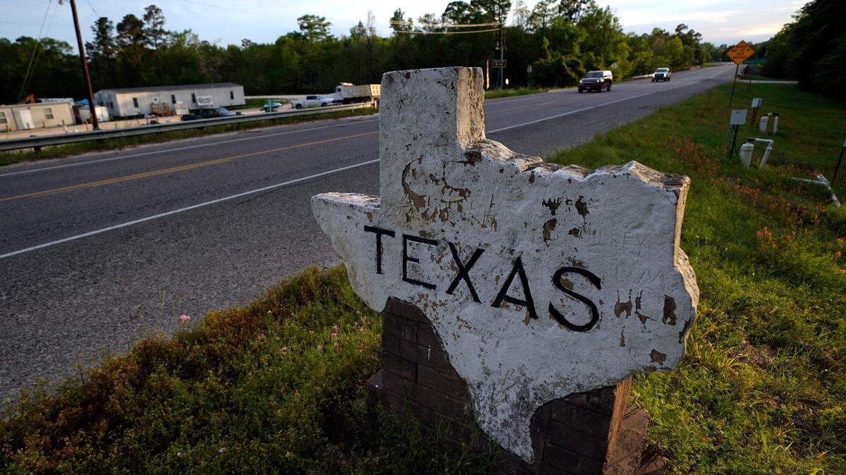 A Texas welcome sign is shown Sunday, March 29, 2020, in Deweyville, Texas, near the Louisiana state border.