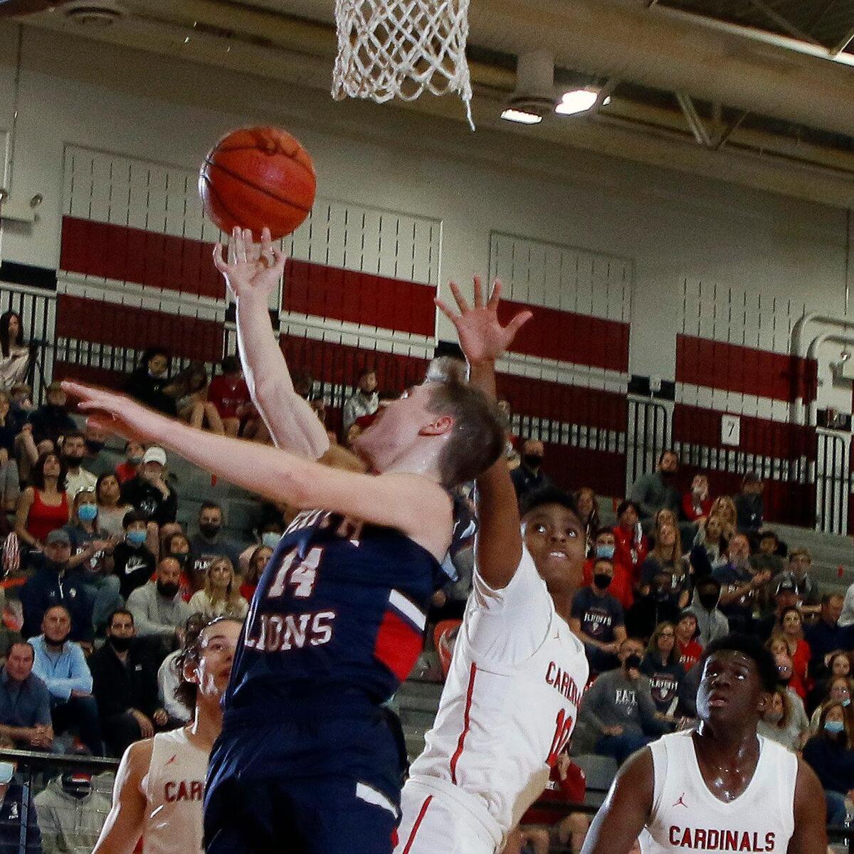 Grapevine Faith’s Grant Rein (14) drops in two defended by Fort Worth Christian’s Courtland Barbarin (10) during the TAPPS 5A State Semifinal basketball game at Colleyville Heritage High School in Colleyville, Texas, Tuesday, March 09, 2021. Fort Worth Christian led 38-27 at the half. (Special to the Star-Telegram Bob Booth)