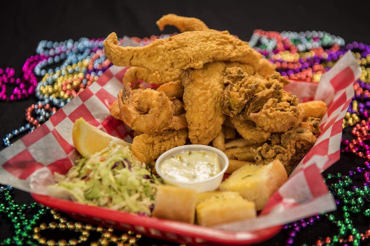 The seafood platter at Lost Cajun: fried shrimp, catfish and oysters, along with seasoned fries, garlic bread and coleslaw.
