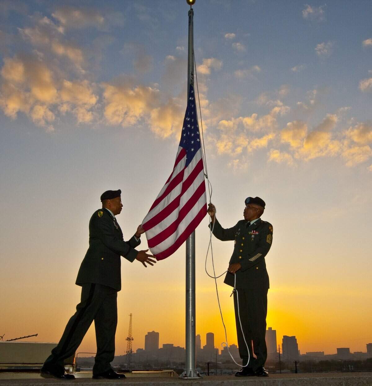 Nov. 11, 2009: Lt. Col. Richard Crossley, senior Army JROTC instructor at North Side High School, and 1st Sgt. Franklin Lashley, Army JROTC instructor, help a JROTC contingent from the school hoist a U.S. flag above the Fort Worth ISD administration building. The flag flew over an undisclosed military facility in the Middle East and was provided by the spouse of a district employee.