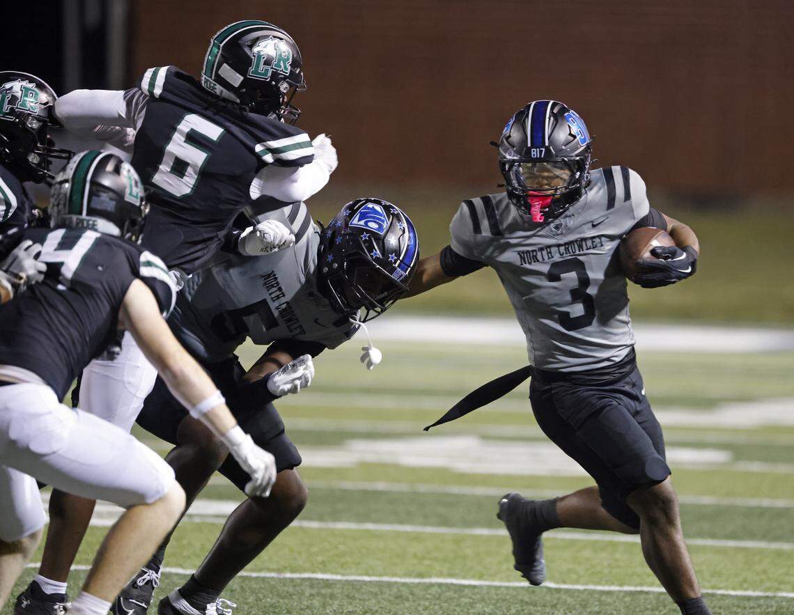 North Crowley running back G’Yrell Smith (3) stiff arms his way out of the pile during the first half of a UIL football game between North Crowley and Lake Ridge at Vernon Newsom Stadium in Mansfield, Texas, Thursday, October 9, 2025.