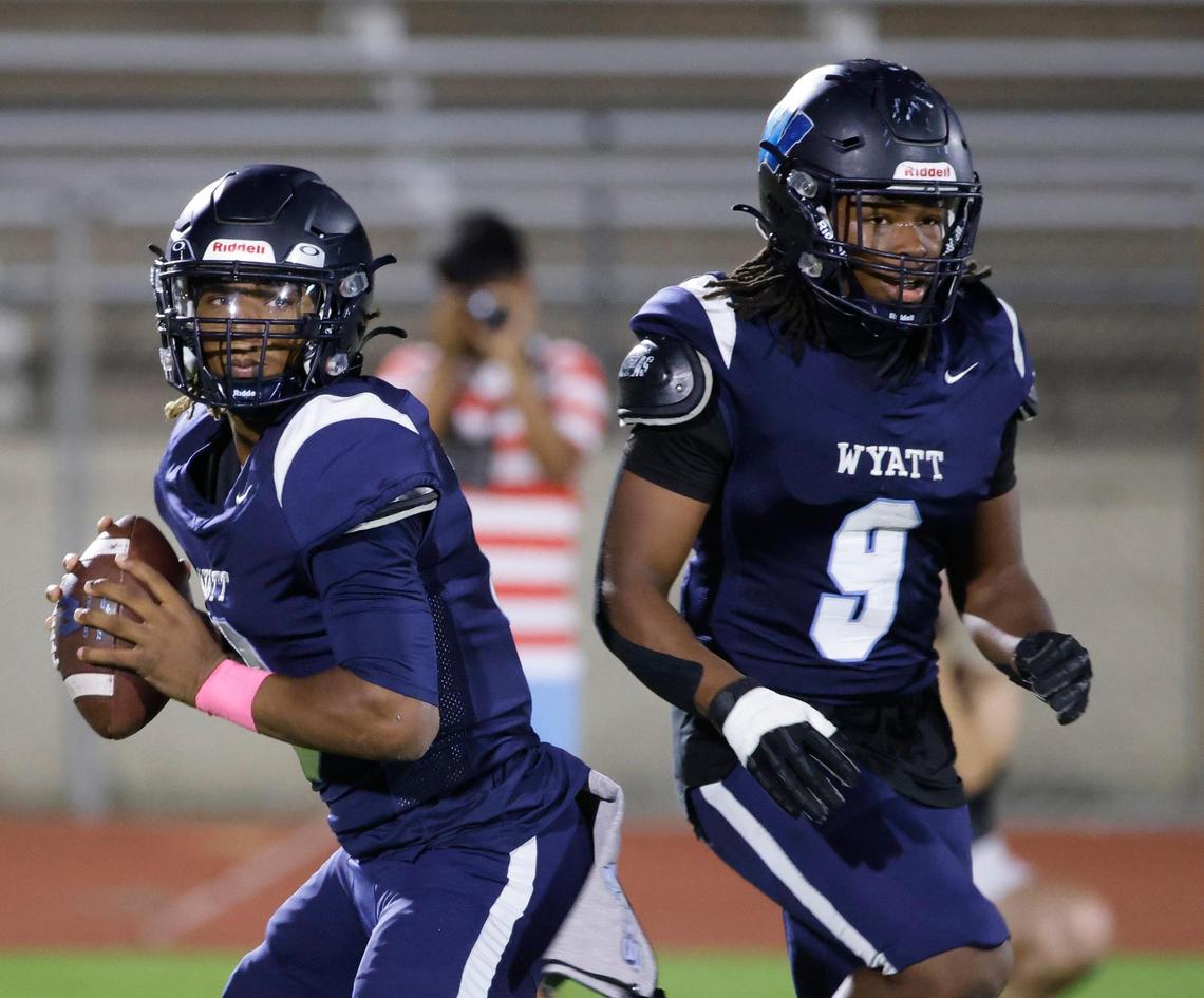 Wyatt quarterback Jorvorskie Lane (13) passes to the flat protected by running back Dale Brown (9) during a District 4-5A Division 1 football game at Herman Clark Stadium in Fort Worth, Texas, Thursday, Oct. 24, 2024.