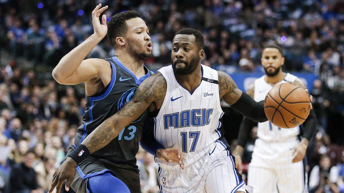 Orlando Magic forward Jonathon Simmons (17) battles Dallas Mavericks guard Jalen Brunson (13) for space during the first half of an NBA basketball game, Monday, Dec. 10, 2018, in Dallas. (AP Photo/Brandon Wade)