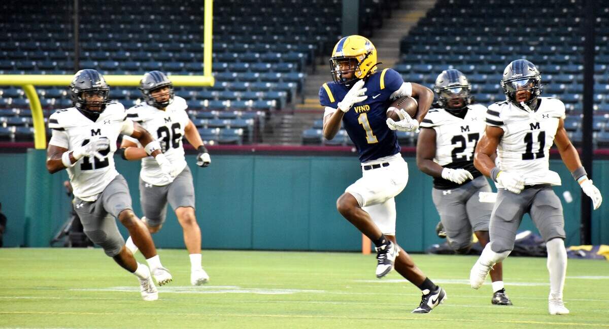 Arlington Lamar’s Xian Johnson outruns four Arlington Martin defenders on his way to a touchdown in the first quarter of a UIL football Class 6A game at Choctaw Stadium in Arlington on Thursday, Sept. 18, 2025. A penalty negated the 75-yard score, but on the next drive, he scored an 86-yard touchdown.