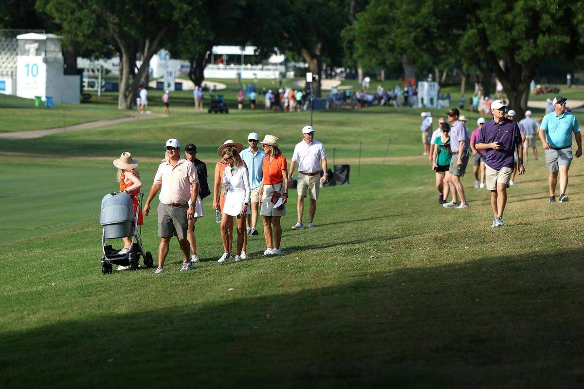 Spectators walk to the next hole while watching the first round of the Charles Schwab Challenge on Thursday, May 25, 2023, at Colonial Country Club in Fort Worth.