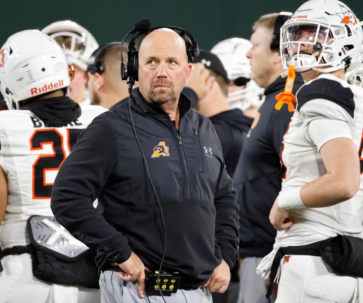 Aledo head coach Robby Jones glances to the big screen during a injury time out in the second half of a Conference 5A Division 1 UIL Regional football playoff game at Choctaw Stadium in Arlington, Texas, Friday, Oct. 24, 2023.