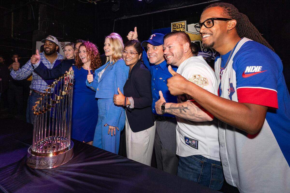 Fort Worth Mayor Mattie Parker, center, and other members of city council take a photo with the World Series Commissioners Trophy during a Texas Rangers World Series celebration event at Billy Bob’s Texas in Fort Worth on Thursday, Nov. 9, 2023.