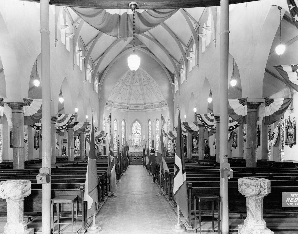 Interior of St. Patricks Catholic Church draped with flags.