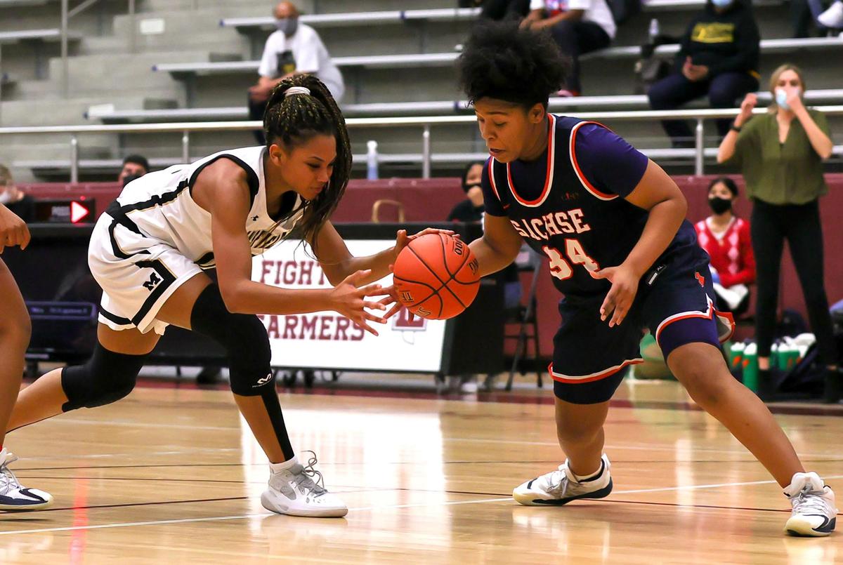 Mansfield post Zarria Carter (L) goes for a loose ball against Sachse guard Neenah George (34) during the first half of the 6A Region II Girls Basketball Area -Round 2 played February 23, 2021 at Lewisville High School. (Steve Nurenberg Special to the Star-Telegram)