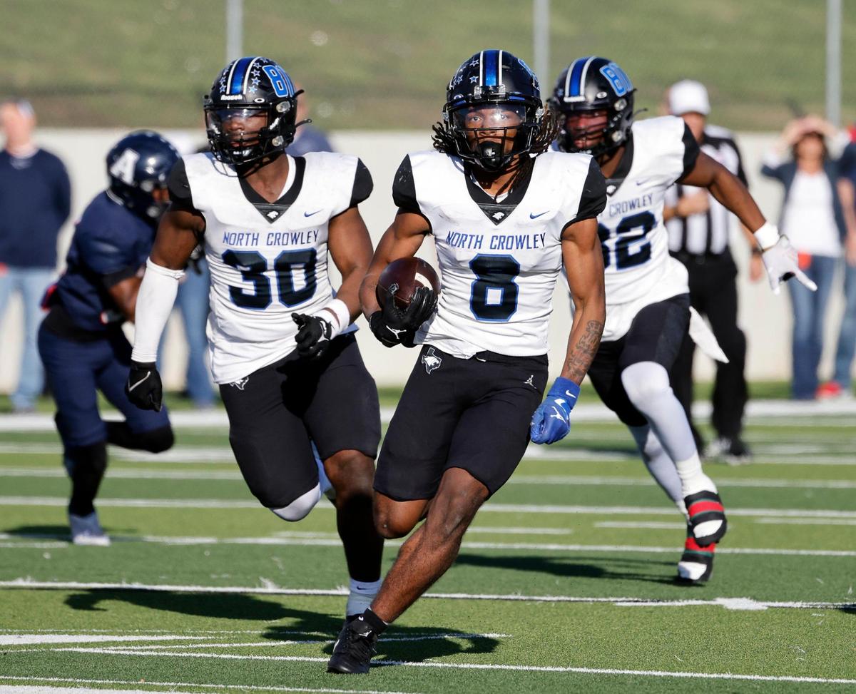 North Crowley running back Ashton Searl (8) heads up field ahead of his blockers during the second half of a UIL Conference 6A Division 1 quarterfinal football playoff game at Dragon Stadium in Southlake, Texas, Saturday, Dec. 02, 2023.