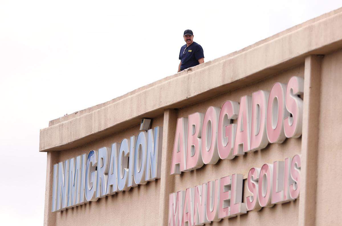 FBI agents investigate the scene where a shooting at an Immigration and Customs Enforcement facility occurred in Dallas on Wednesday, Sept. 24, 2025.