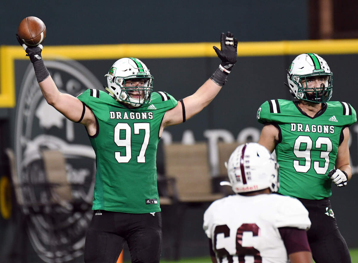 Southlake Carroll’s Jayke Coberly, left, celebrates with the football and teammate Grayson Repass after sacking Midland Legacy’s quarterback for the second time the fourth quarter of their Class 6A Division 1 Area football game Saturday, November 20, 2021 at Globe Life Field in Arlington, Texas. Carroll went on to win 42-7. Special/Bob Haynes