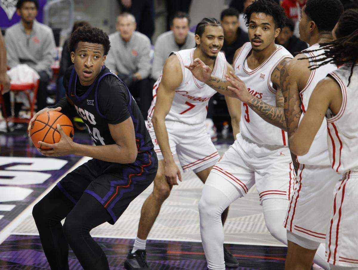 TCU forward Xavier Edmonds (24) grabs an offensive rebound in front of Houston during the first half of a NCAA basketball game between the University of Houston and TCU at Schollmaier Arena in Fort Worth, Texas, Wednesday Jan. 26, 2026