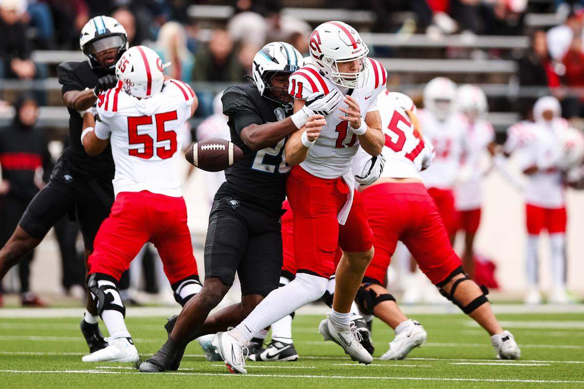 Coppell quarterback Carter Zingelmann (11) is tackled and stripped of the ball from behind by North Crowley linebacker Brock Lacy in a Class 6A Division I regional playoff Saturday, Nov. 29, 2025, at Midlothian ISD Stadium in Midlothian.