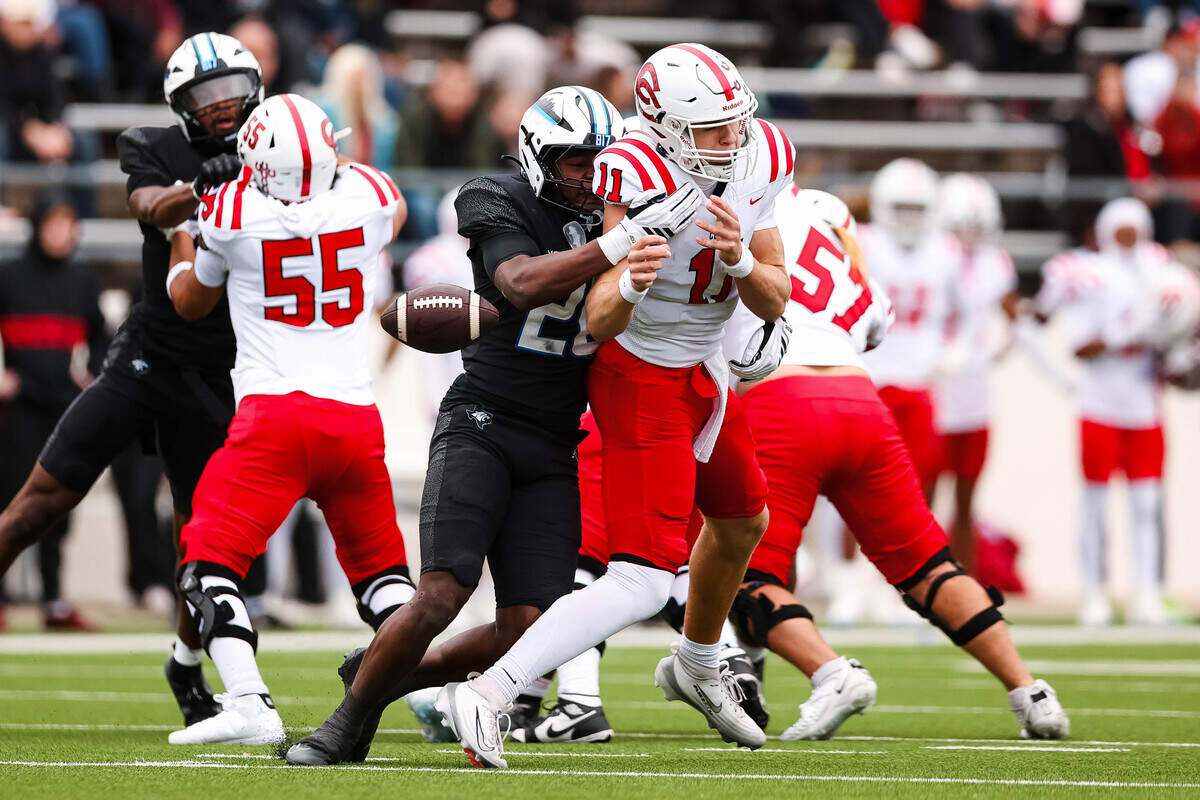Coppell quarterback Carter Zingelmann (11) is tackled and stripped of the ball from behind by North Crowley linebacker Brock Lacy in a Class 6A Division I regional playoff Saturday, Nov. 29, 2025, at Midlothian ISD Stadium in Midlothian.