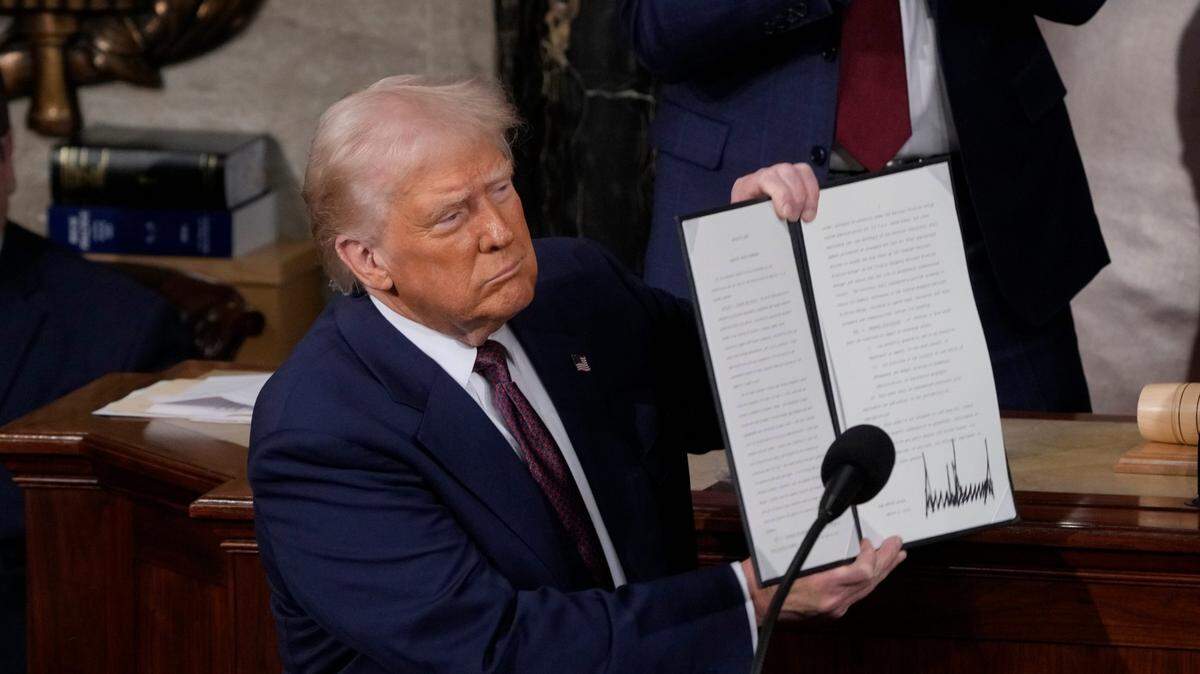 President Donald Trump holds up an executive order that renames a wildlife sanctuary in honor of the late Jocelyn Nungaray, a 12 year-old girl who was allegedly murdered by two undocumented migrants, during an address to a joint session of Congress at the U.S. Capitol in Washington, D.C., on March 4, 2025.