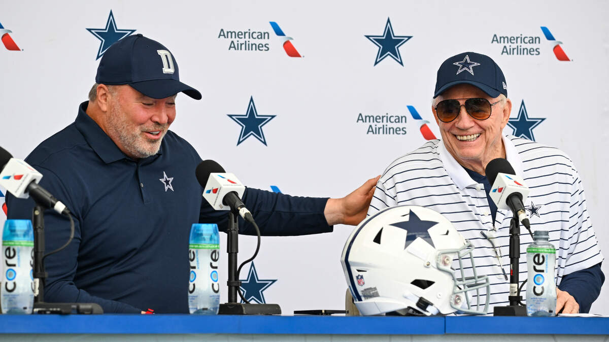 Dallas Cowboys head coach Mike McCarthy, left and owner Jerry Jones, right, react as they take questions from the media at the start of NFL football training camp on Tuesday.