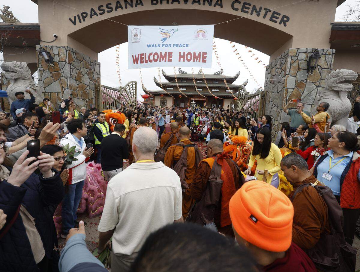 More than 1,200 people packed the entrance and grounds of the center to welcome the Buddhist monks who walked nearly 2,300 miles to Washington, D.C., for peace as they arrived back at the Húóng Dao Vipassana Bhavana Center in Fort Worth, Texas, on Saturday, Feb. 14, 2026.