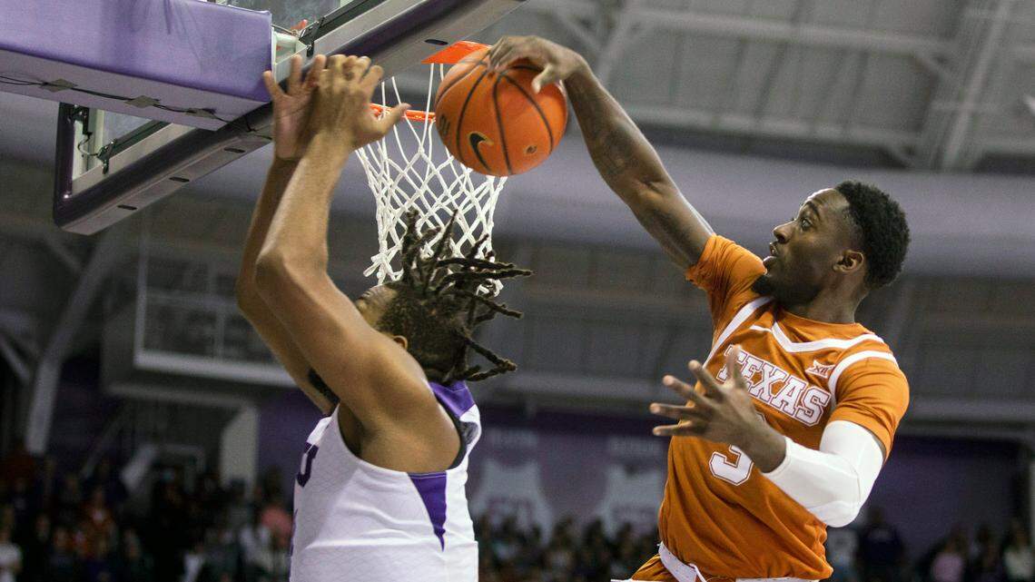 Texas guard Courtney Ramey, right, blocks TCU center Eddie Lampkin, left, in the first half of Tuesday’s game in Fort Worth.