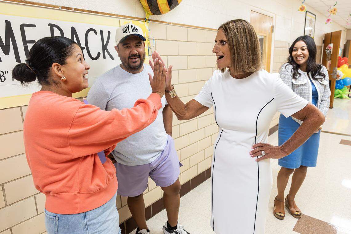 Fort Worth ISD Superintendent Karen Molinar, right, greets parents to begin the first day of instruction at Mary Louise Phillips Elementary School in Fort Worth on Tuesday, Aug. 12, 2025.